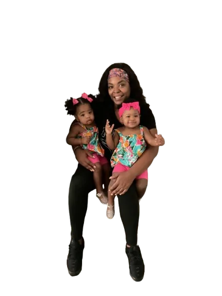 Tamika (Mi-Mi) hugging her twin granddaughters Malaiya and Miyanna
